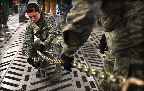 Airman 1st Class Emily Miller, an aerospace ground equipment mechanic with the 180th Fighter Wing, practices securing cargo with a heavy chain inside the cargo hold of a C-17 Globemaster III.