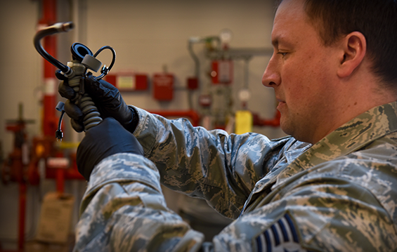 Tech. Sgt. Jon Pieron, an aircrew flight equipment craftsman with the 180th Operations Support Squadron, inspects a pilot's oxygen mask.