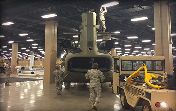 Soldiers from the Ohio Army National Guard's Company B, 3rd Battalion, 238th Aviation Battalion, with the help of the active Army's 160th Special Operations Aviation Regiment, move an Ohio CH-47F "Chinook" helicopter into the Gaylord Opryland Convention Center.