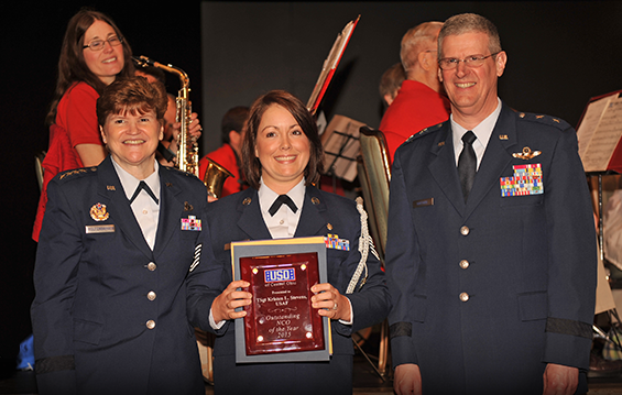 Gen. Janet C. Wolfenbarger (left), the Air Force's first female four-star general and current commander of Air Force Materiel Command at Wright-Patterson Air Force Base, Ohio, and Maj. Gen. Mark E. Bartman (right), Ohio adjutant general, present a USO of Central Ohio award for Outstanding NCO of the Year to Tech. Sgt. Kristen L. Stevens.