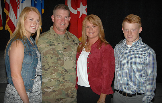 Col. Craig Baker stands with his Family following his promotion ceremony 