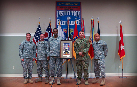 U.S. Army War College 2015 class graduates Col. Stephen Rhoades (from left), Lt. Col. Thomas Moore, Lt. Col. David Mason Jr. and Lt. Col. Jeffrey Suver present a print of the stained glass window, which was the class’ gift that is displayed at Carlisle Barracks, Pa., to the Ohio Army National Guard and Maj. Gen. John C. Harris Jr., Ohio assistant adjutant general for Army.