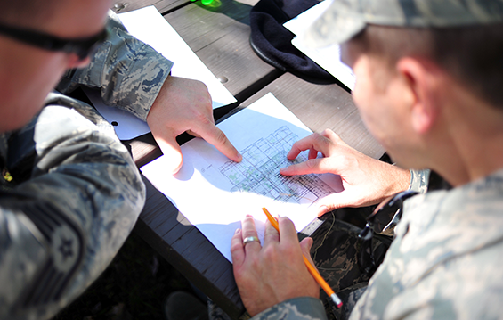 Security Forces Airmen of the 180th Fighter Wing prepare to start a land navigation course by examining a map grid.