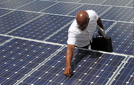 Ronald Gooch, energy specialist for the Ohio Adjutant General’s Department, inspects a solar panel.