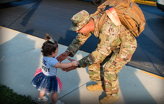 Staff Sgt. David K. White, of the 1194th Engineer Company, greets his toddler daughter.