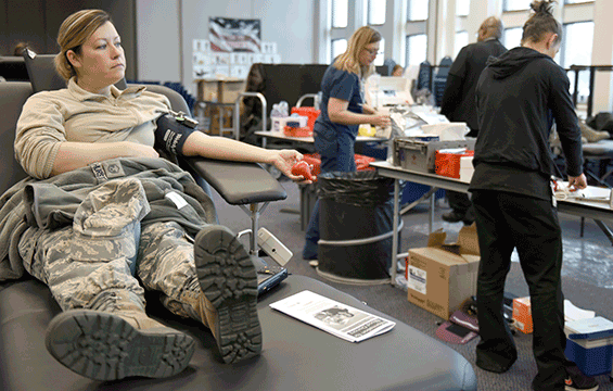 Master Sgt. Melissa Hurst, the comptroller superintendent for the 180th Fighter Wing, waits while technicians prepare for her donation during an American Red Cross blood drive.