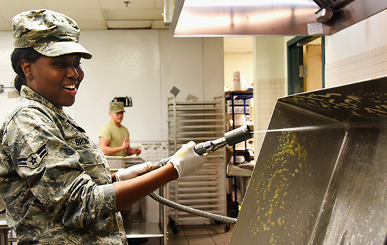Airman 1st Class Patrice Brown of the 178th Wing Force Support Squadron sprays down a grill.