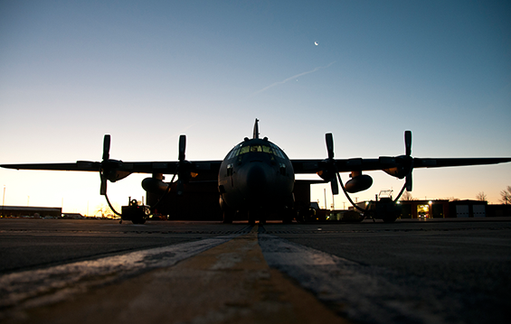 A C-130H Hercules sits on a cold flight line as heaters prepare the turbo prop engines for the day’s mission.