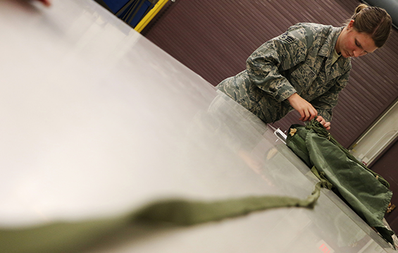 Senior Airman Jamie Dyer of the 179th Aerial Port Squadron prepares a parachute for air drop.