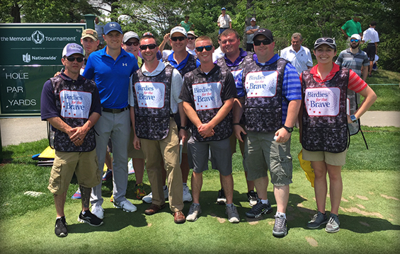 PGA Tour player Jordan Spieth stands with military service members who were serving as caddies during the Nationwide Invitational Pro-Am.