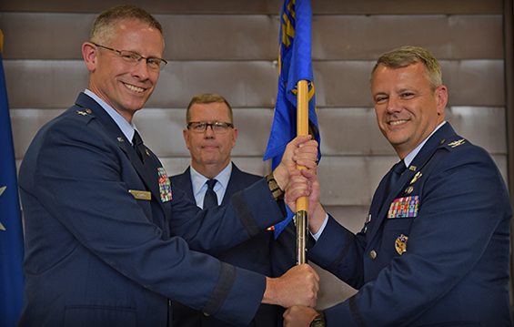 Brig. Gen. Gregory Schnulo (left), Ohio assistant adjutant general for Air, hands the 178th Wing guidon to Col. John Knabel (right), incoming 178th Wing commander.
