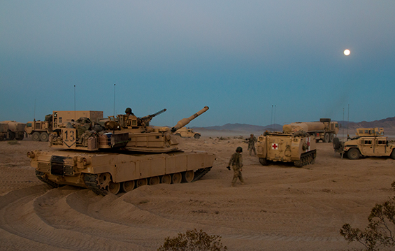 Soldiers with the 1st Battalion, 145th Armored Regiment prepare for a night assault .