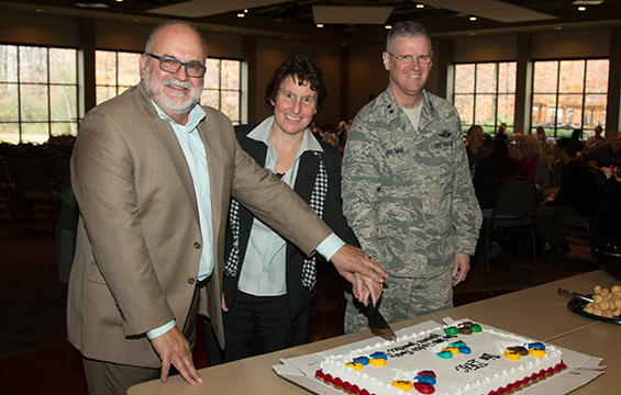 Mike Magnusson (from left), a transition assistance advisor for the Ohio National Guard, Julie Blike, director of ONG Family Readiness and Warrior Support, and Maj. Gen. Mark E. Bartman, Ohio adjutant general, prepare to cut a cake to celebrate the 10th anniversary of the Inter-Service Family Assistance Committee.