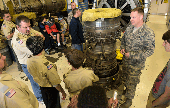 Tech. Sgt. Paul Stutzenstein, a jet engine mechanic with the 180th Fighter Wing, shows Boy Scouts from Troop 103 in Maumee an up-close look at the engine that powers the F-16 Fighting Falcon.