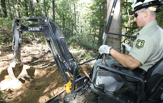 Ohio Army National Guard 1st Lt. Nick Mossbarger of the 216th Engineer Battalion uses an excavator.
