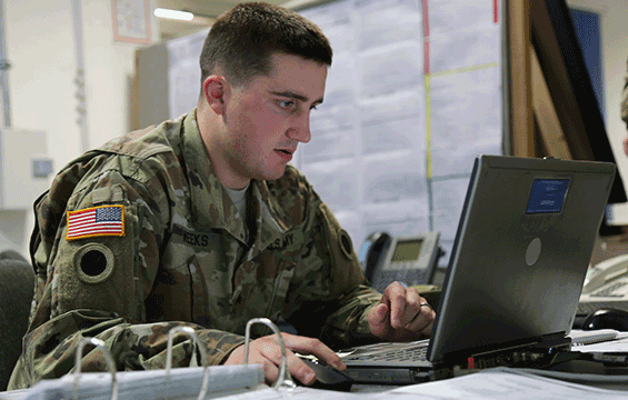 A Soldier works on laptop during a Kosovo Force (KFOR) mission rehearsal exercise 