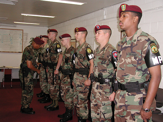 A sergeant with the 135th inspects his Soldiers prior to their guard duty shift in 2002 at Fort Bragg. 