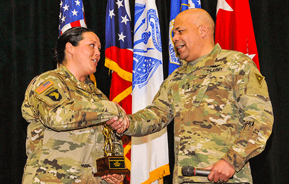 Ohio assistant adjutant general for Army, presents Staff Sgt. Michelle Poole with the Ohio National Guard Exceptional Victim Advocate of the Year award.