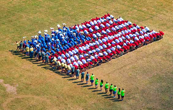 Participants at Ohio Military Kids Camp Kelleys Island, a camp for children of military service members, form the shape of the American flag.