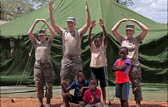 Guard members form "O-H-I-O" with children from Angola.