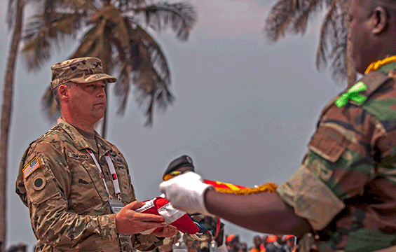 U.S. Army Col. Kevin Edwards, an Ohio National Guard nurse practitioner, accepts the U.S. Flag during of the exchanging of flags.
