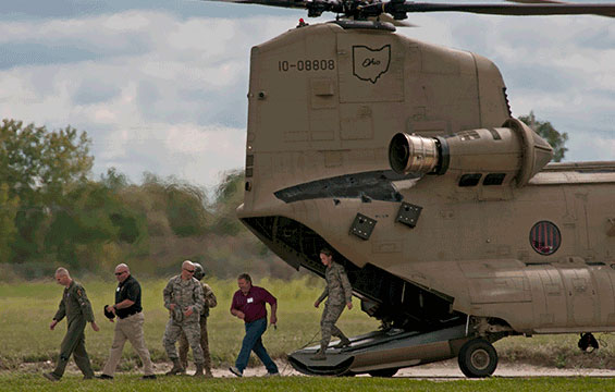 Civilian employers of Ohio National Guard members exit a CH-47 Chinook helicopter.