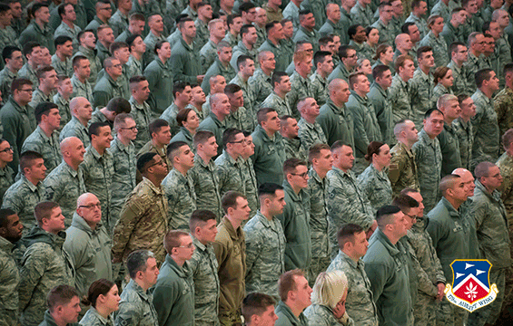 Airmen standing in rows facing right.