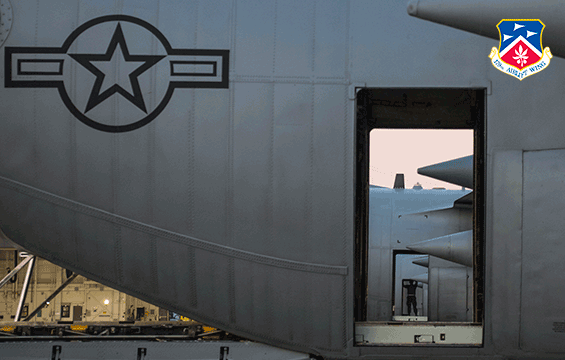 closeup of C-130H open door, with 2 other c-130s with open doors lined up.
