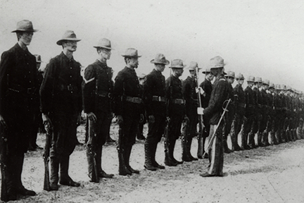 An officer inspects the weapon of a Soldier during morning formation, 1898