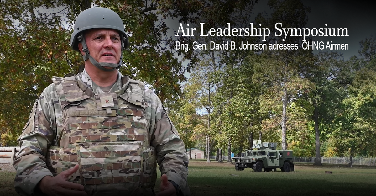 Airguard members climb over wall