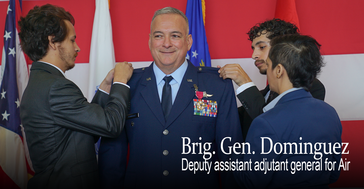 Brig. Gen. Domingues gets his uniform pinned by his kids.