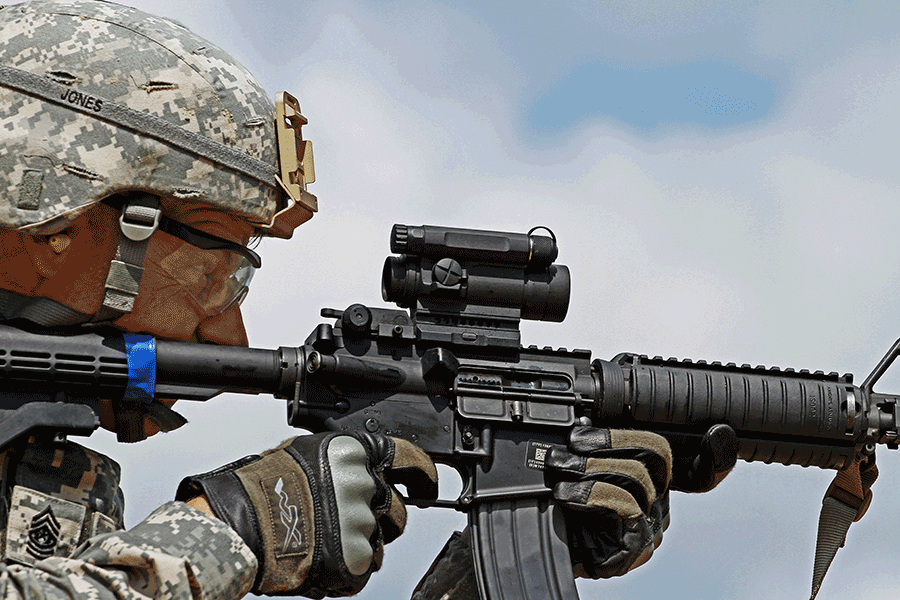 Command Sgt. Maj. Jones closeup profile firing M4Carbine weapon.