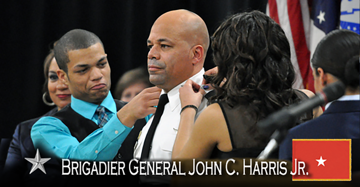 Brig. General John C. Harris, Jr. is pinned by his son and daughter.