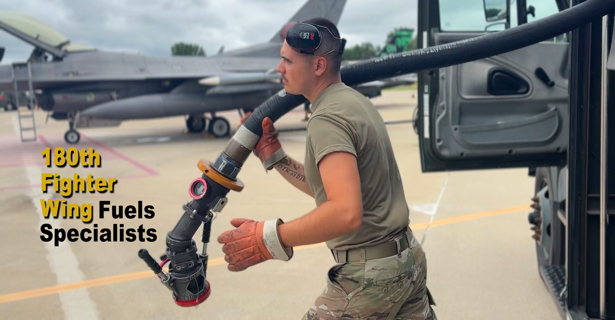 Airman carries hose from truck on tarmac
