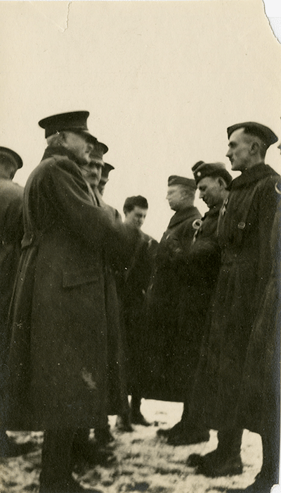 black and white photo of general greeting soliders