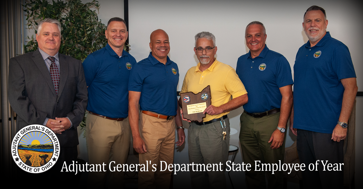 Tim Morgan, fourth from left, an environmental supervisor for the Ohio National Guard, receives the Ohio Adjutant General’s Department 2023 State Employee of the Year Award from OHNG senior leaders during a department town hall meeting at the Quest Conference Center in Columbus, Ohio, Oct. 4, 2023. Morgan has been in the position for nearly 25 years and has been an integral part of the Camp James A. Garfield Joint Military Training Center team, assisting with the sustainable growth, development and environmental stewardship at the installation.