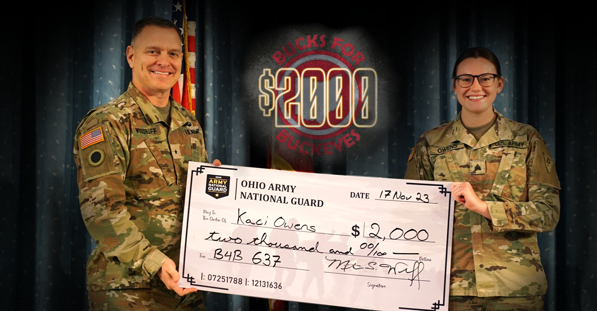 Brig. Gen. Matthew S. Woodruff, left, Ohio assistant adjutant general for Army, presents Sgt. Kaci Owens, of the 637th Chemical Company, with a $2,000 recruitment incentive check through the Ohio National Guard’s new Bucks for Buckeyes lead referral program during a ceremony at the Defense Supply Center Columbus in Columbus, Ohio, Nov. 17, 2023. Owens is the first Ohio Guard member to receive this incentive through Bucks for Buckeyes, which allows any current or retired OHNG member or current state employee of the Ohio Adjutant General’s Department to receive $2,000 per enlistment for any lead that successfully enters military service and reports for initial military training.