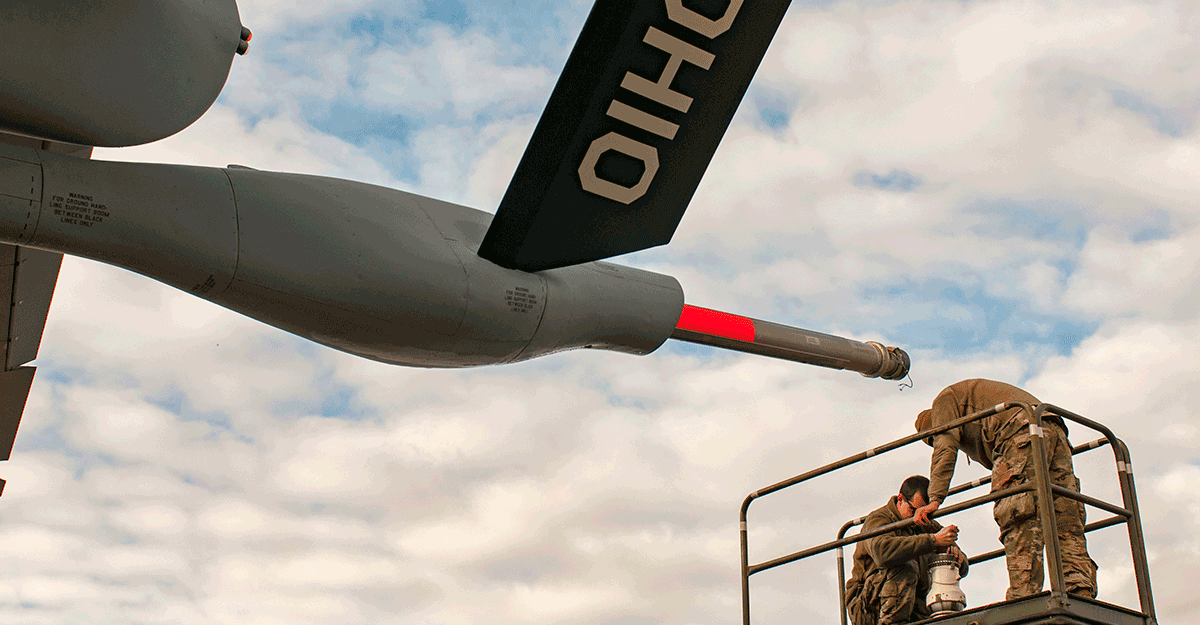 Airmen repair the nozzle on the boom of a KC-135 Stratotanker.