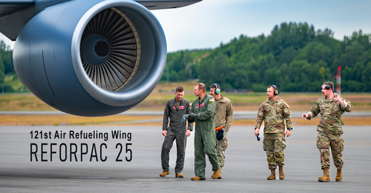 Five Airmen walk around the side of a KC-135 Stratotanker