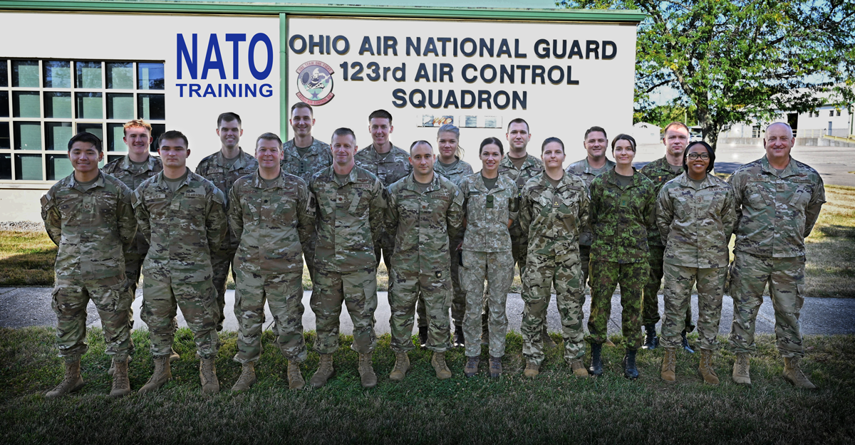 OHANG Airman stand with service members from the United Kingdom, Estonia, Lithuania, and Hungary.