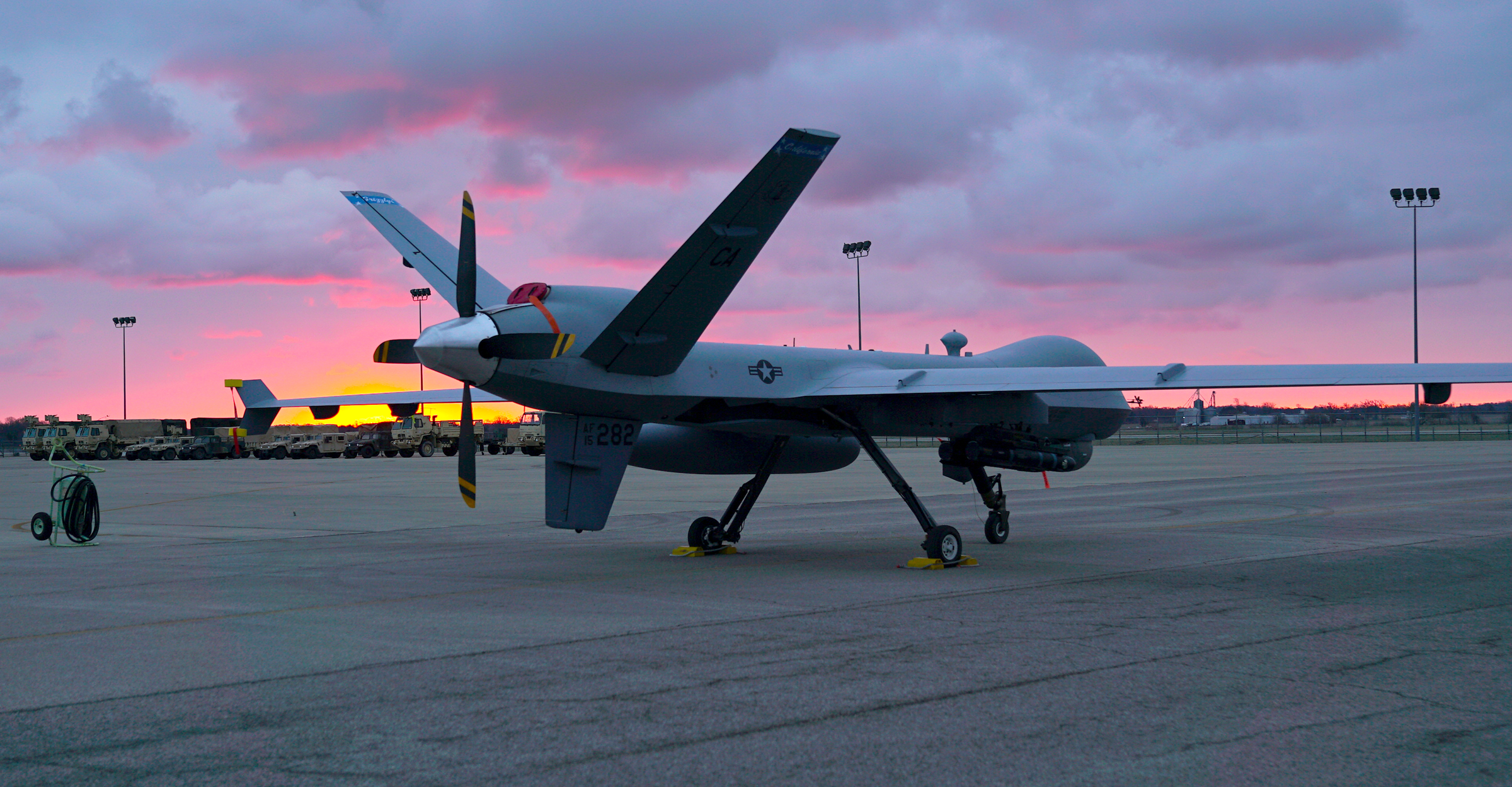 178TH OPERATIONS GROUP:   A remotely piloted MQ-9 Reaper sits in front of a hangar. MQ-9s are usually operated by a two-person team — a rated pilot, who controls flight and an enlisted sensor operator, who manages sensors and weapons — from remote ground control stations, often via satellite.