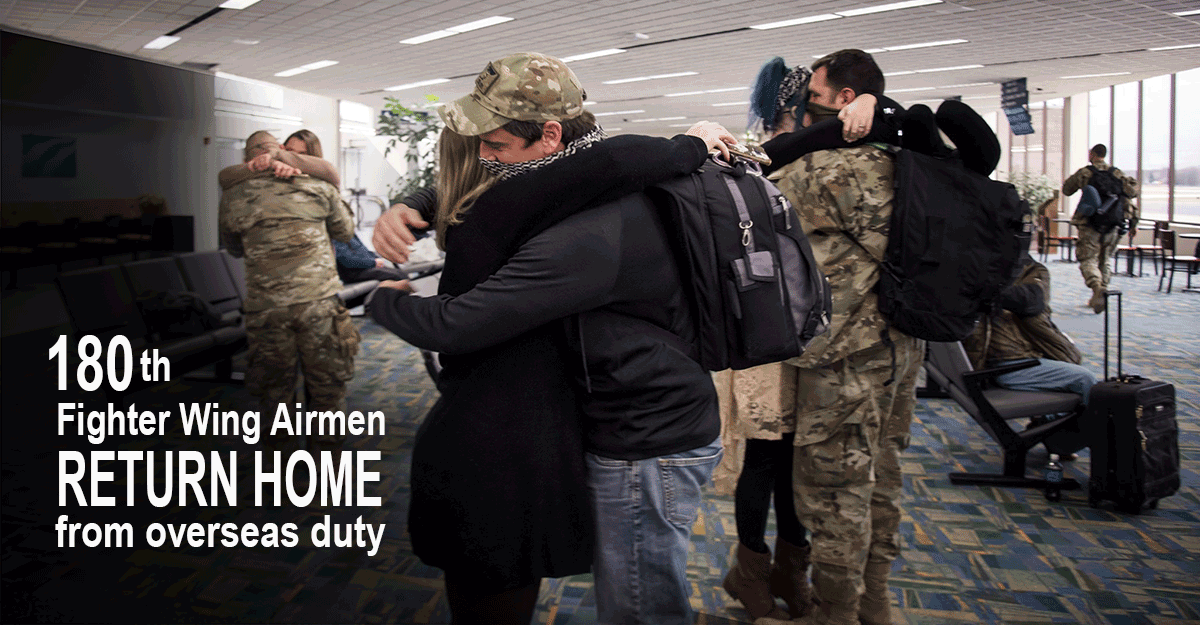Family members embrace returning airmen inside airport.