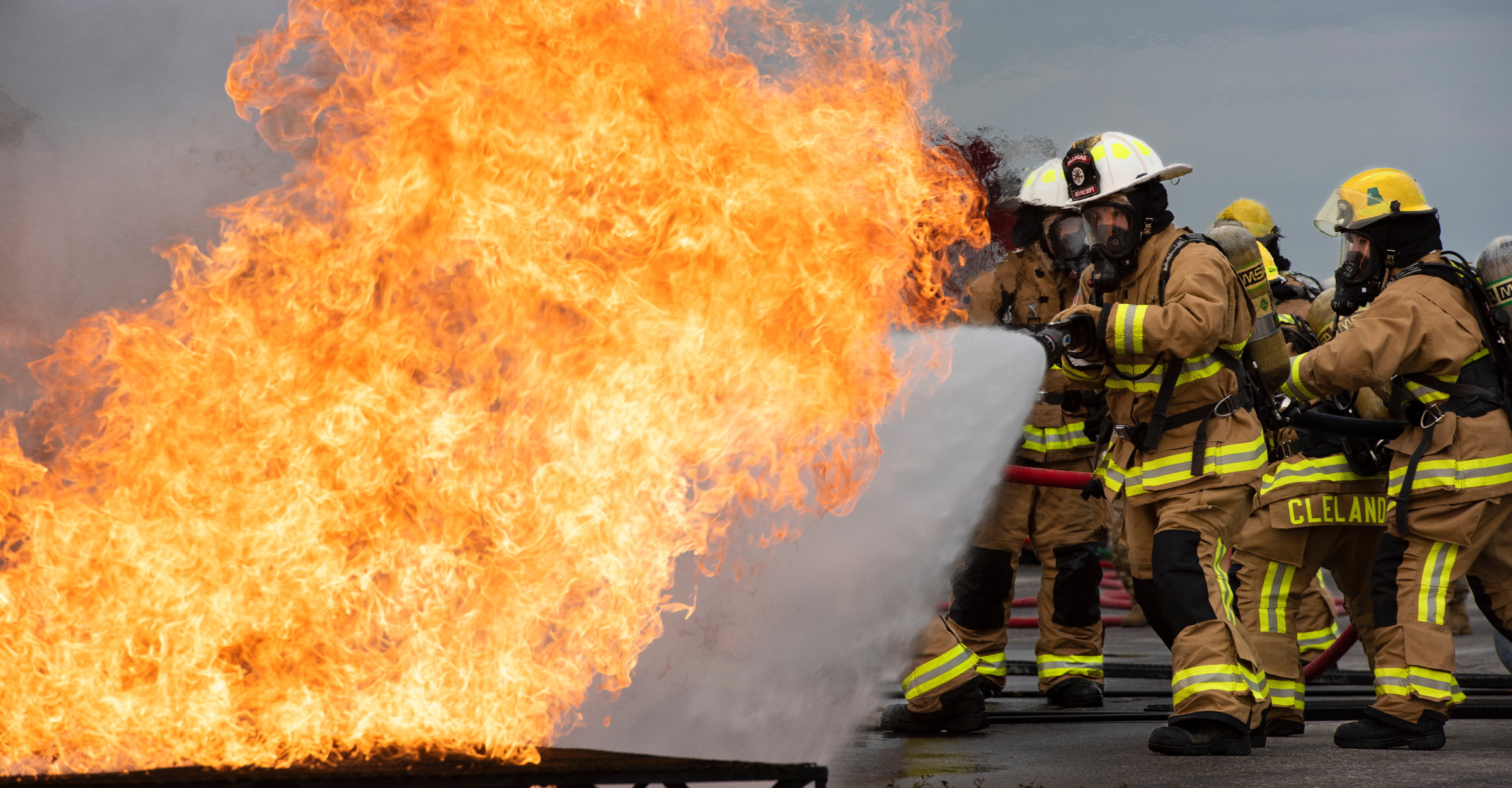 Firefighters work together to help extinguish a fire