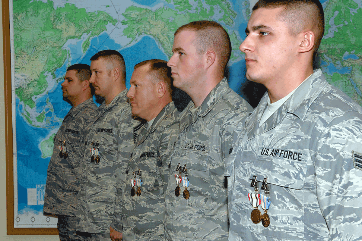 Airmen stand at attention after receiving medals.