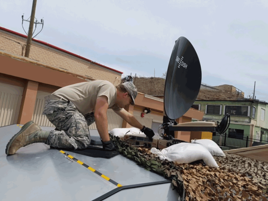 Airman repairing satellite dish