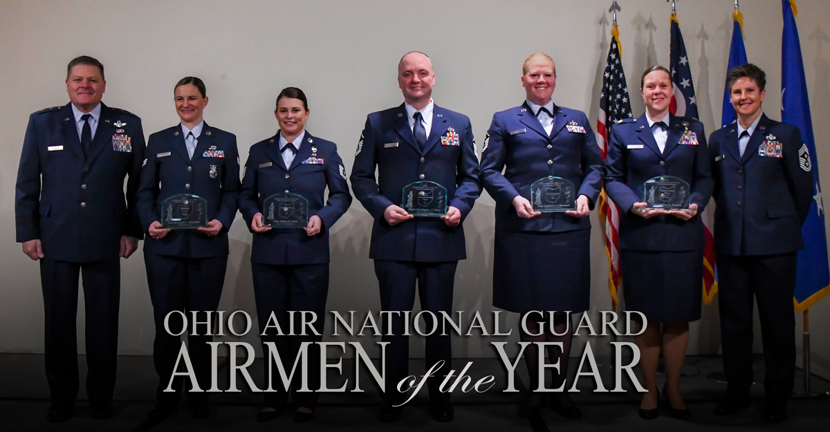 Group of Airmen on stage holding awards. Reads: Ohio Air National guard Airmen of the Year