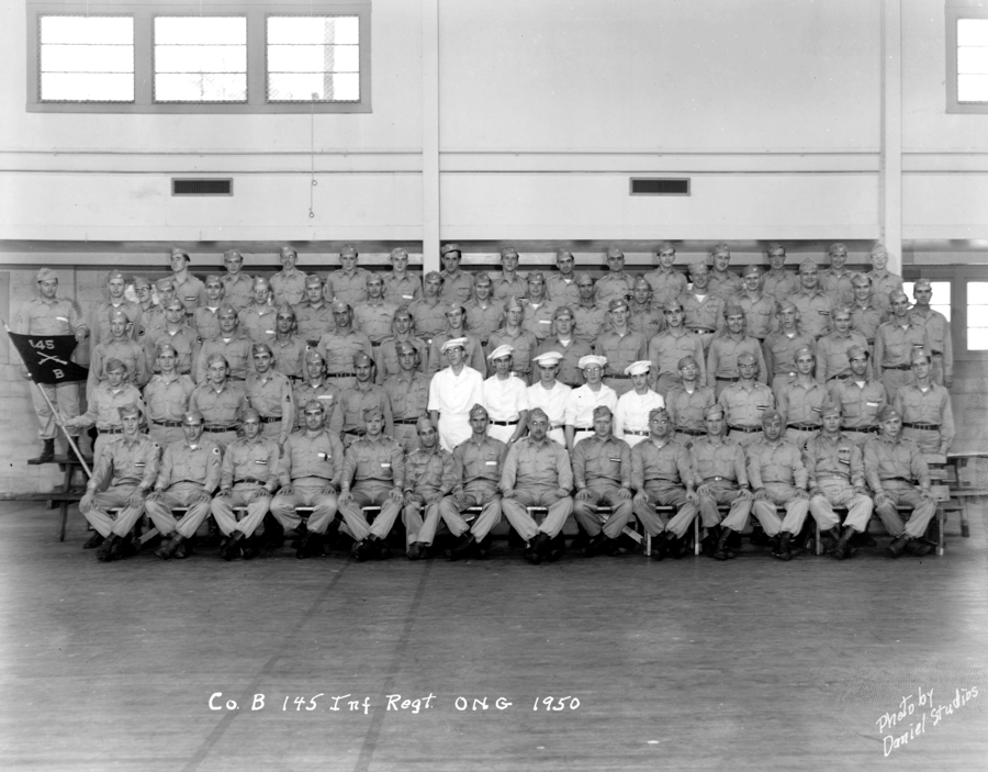 black and white photo of unit sitting in rows inside facility.