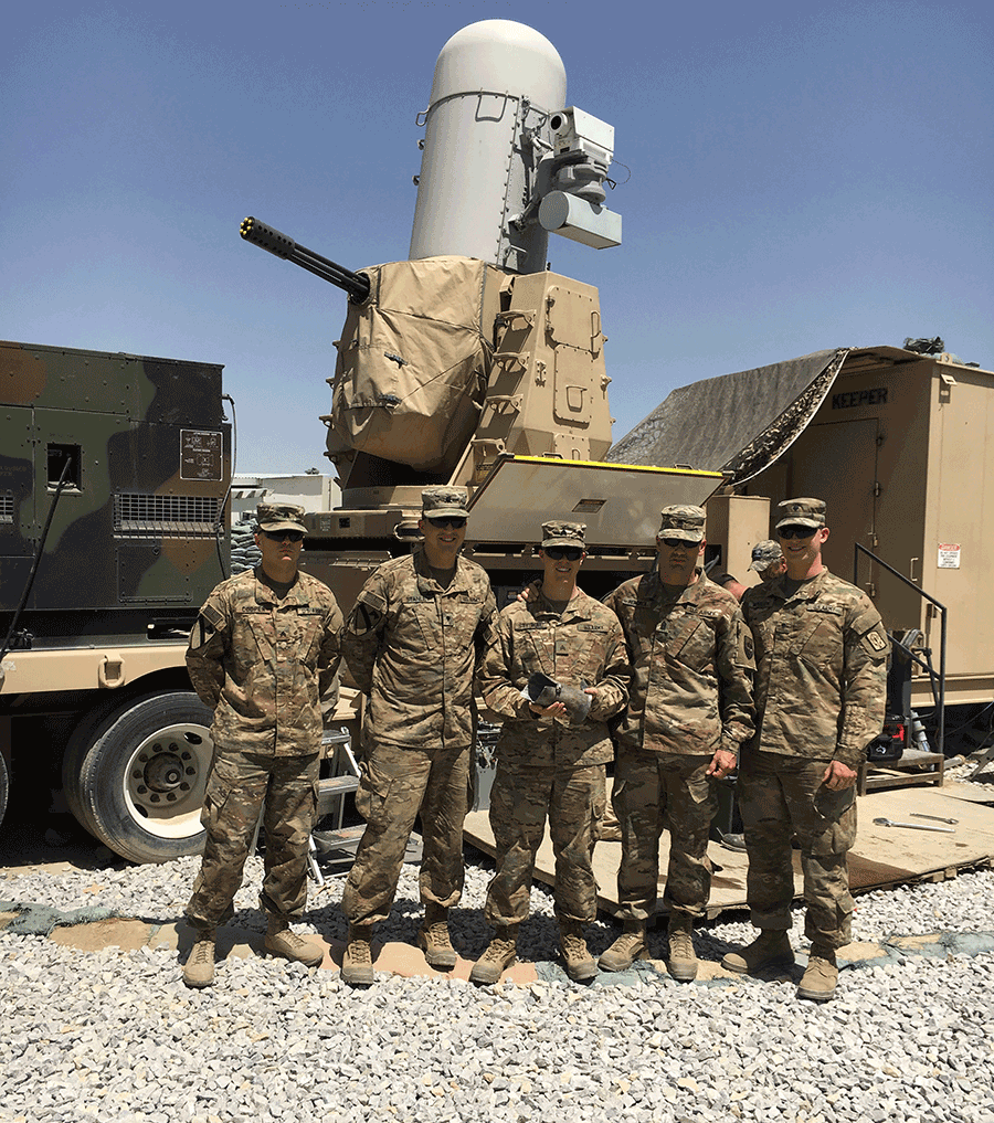 Soldiers stand with Air defense weapon.