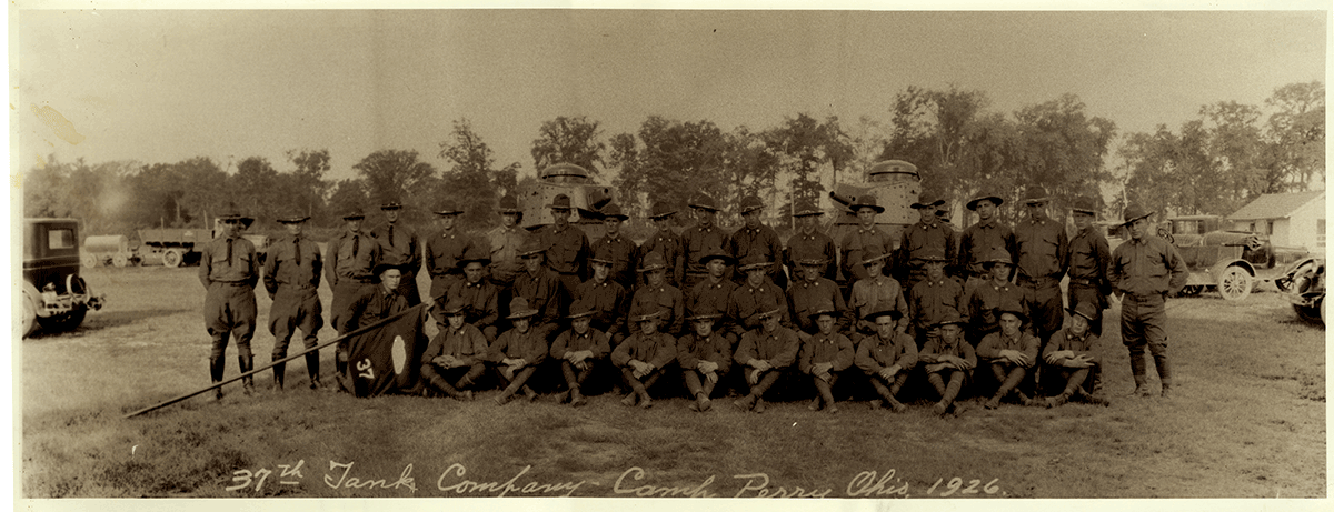 Sepia-tone of troops in rows for group pic.