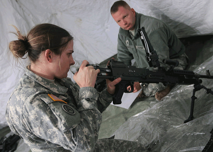 Female soldier assmbles machine gun.